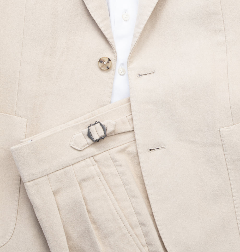 Cream colored suit with a white shirt
