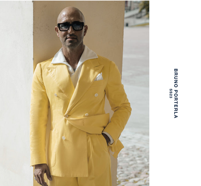 Male wearing a yellow suit with a white shirt